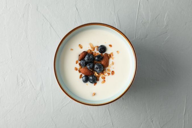 Bowl with parfaits dessert on cement background