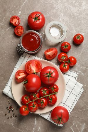 Composition with tomatoes on gray background, top view