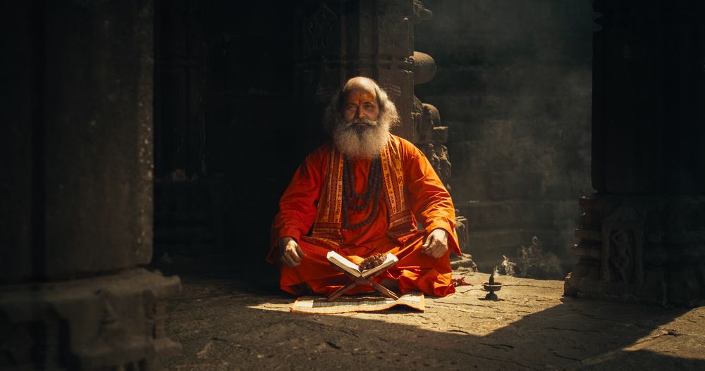 Portrait of a Hindu Monk Looking at the Camera and Smiling in an Ancient Temple.