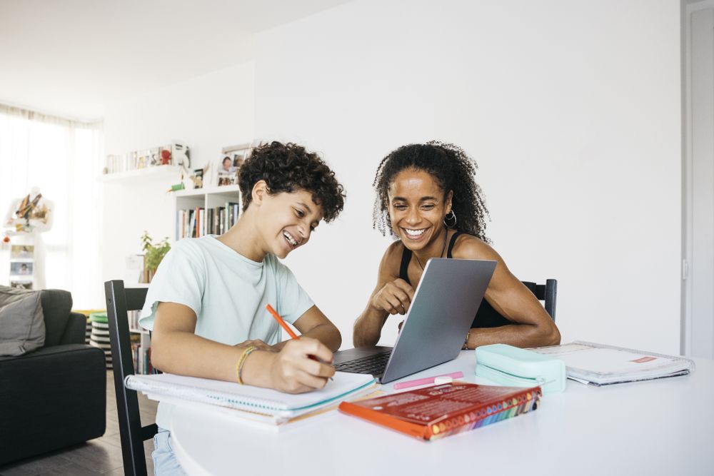 Girl doing her homework with mother