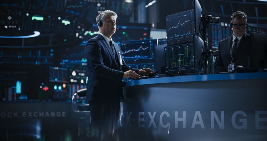 Handsome Stock Exchange Trader Following a Live Auction, Communicating Buy and Sell Orders to Operator on the Other Side of the Call.