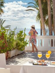 Anonymous woman on terrace of hotel