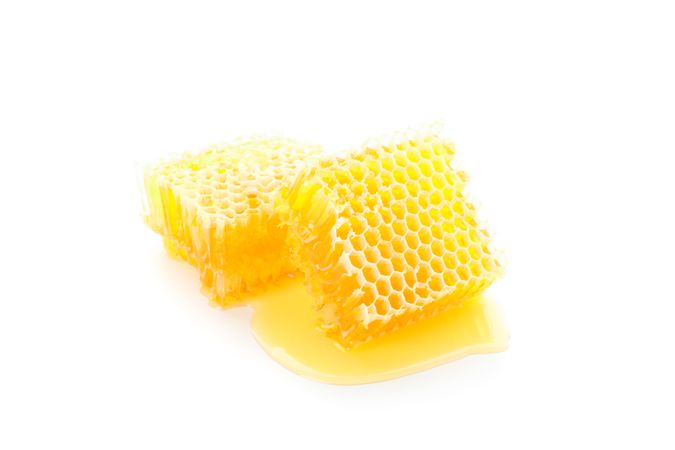 Pieces of honeycomb isolated on blank background, close up