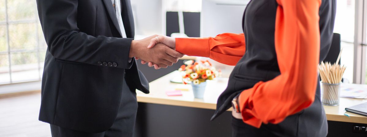 Banner of business people shaking hands in office