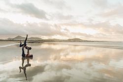 Women exercising near sea