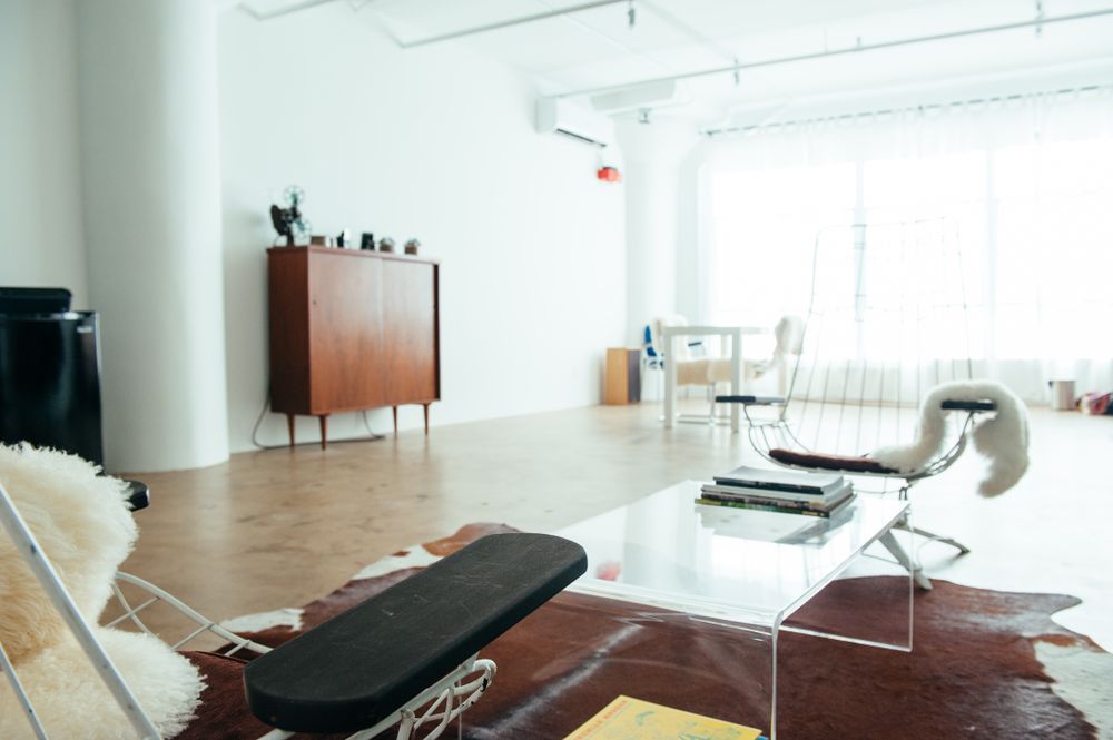Bright, light filled room with large windows and vintage furniture