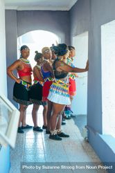 Zulu wedding guests wearing traditional beaded attire and headdresses gather in a hallway bYqe9b