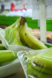 Banana fruits wrapped and for sale in market