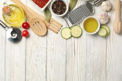 Composition with kitchen cutlery and ingredients for cooking on wooden background, top view
