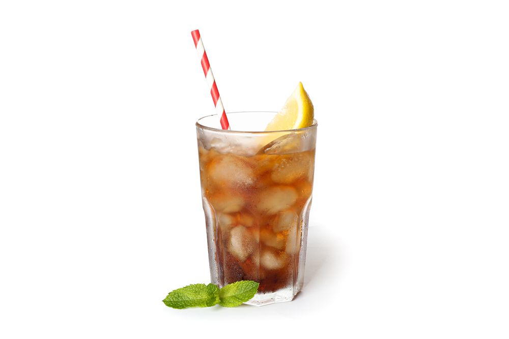 Glass of cold cola with lemon isolated on blank background