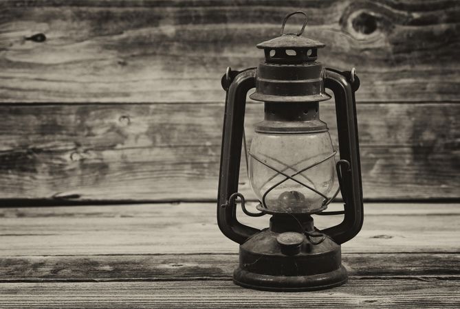 Antique lantern on old wooden table