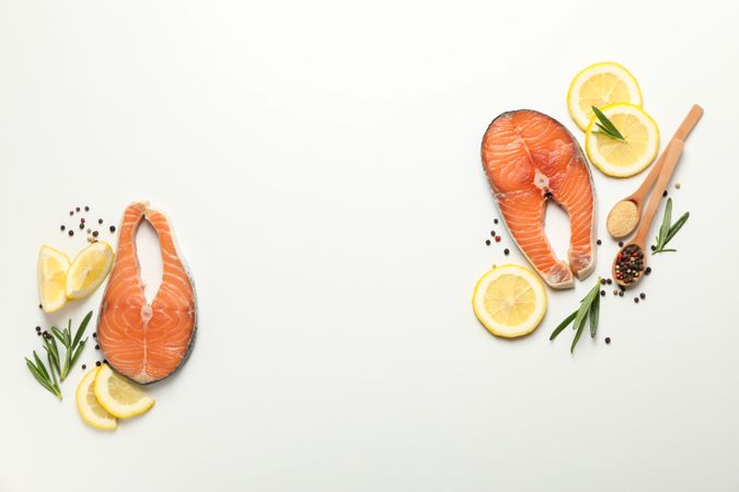 Composition with salmon meat and spices on plain background, top view