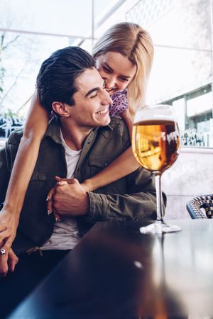 Happy young couple drinking beverages outdoors