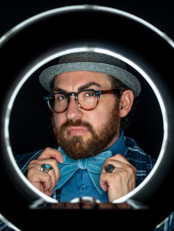 Stylish man in elegant suit behind special circle light