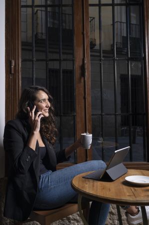 Young female using a mobile phone in cafe
