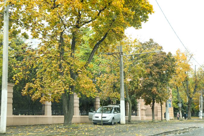 Autumn, cloudy city with a parked car, landscape