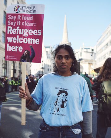 London, England, United Kingdom - March 19 2022: WOC with “Stand up to Racism” sign at protest