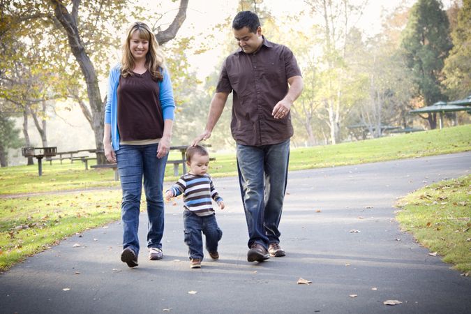 Happy Family Walking In The Park