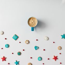 Christmas cookies and red berries with coffee cup