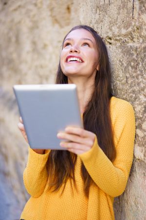 A Happy Young Woman Enjoying Some Engaging Digital Content While Outdoors in the Sun