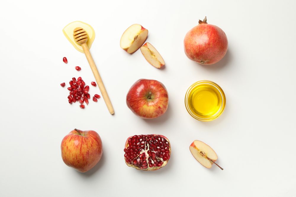 Top view rows of honey, apples, and pomegranate