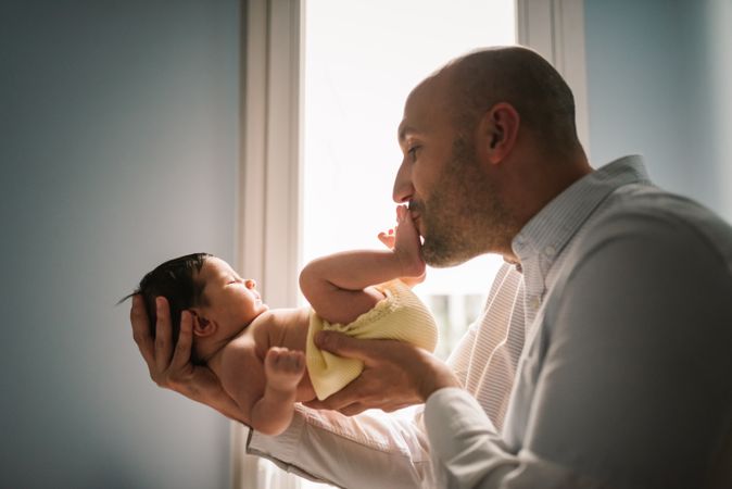 Father kissing baby's foot