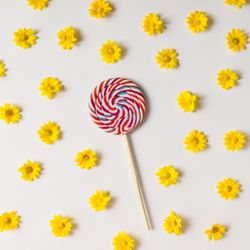 Swirling red lollipop and yellow flowers pattern