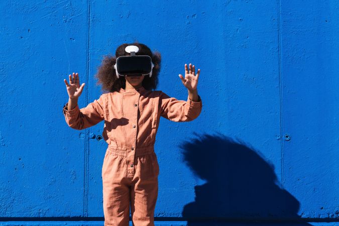 Black teenager in VR headset exploring cyberspace
