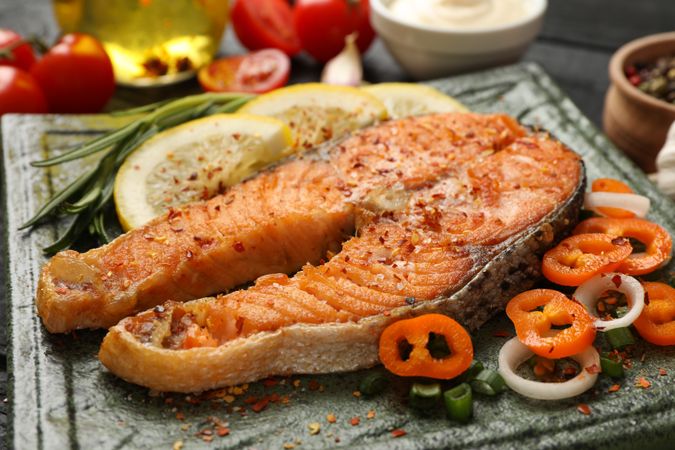 Composition with tasty grilled salmon on wooden background, close up