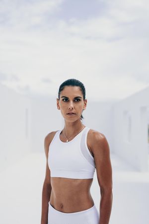 Woman in fitness wear standing and looking away