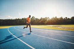 Man jogging on athletic track