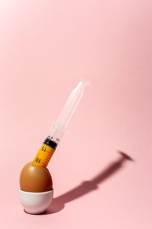 Egg with syringe in eggcup