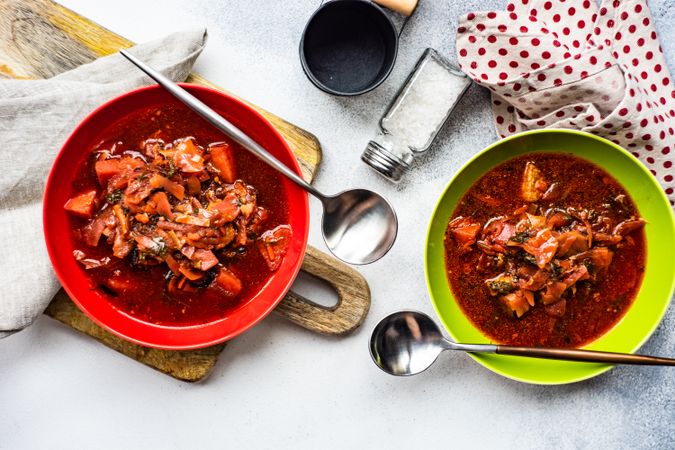 Looking down at two bowls of traditional Ukrainian beetroot soup borscht