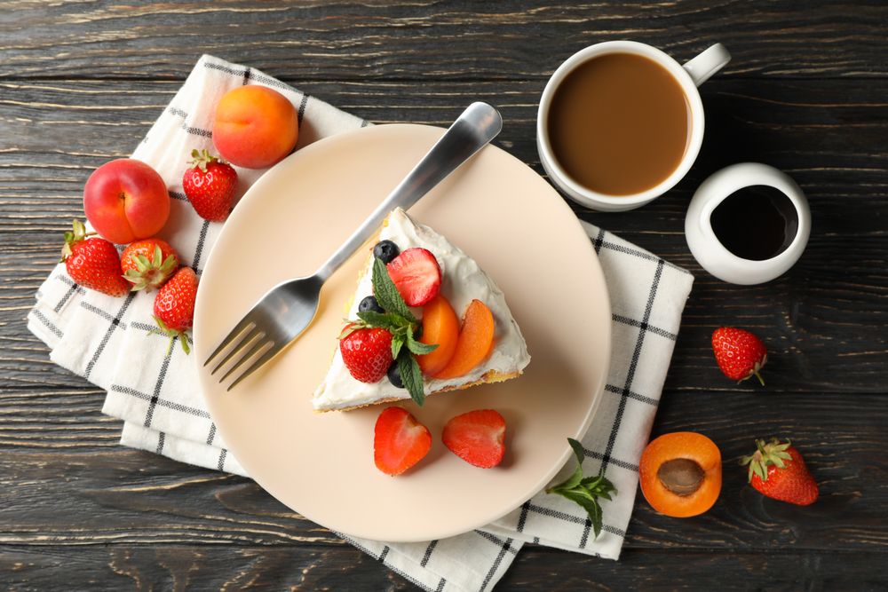 Composition with delicious berry cream cake on wooden table. Tasty dessert