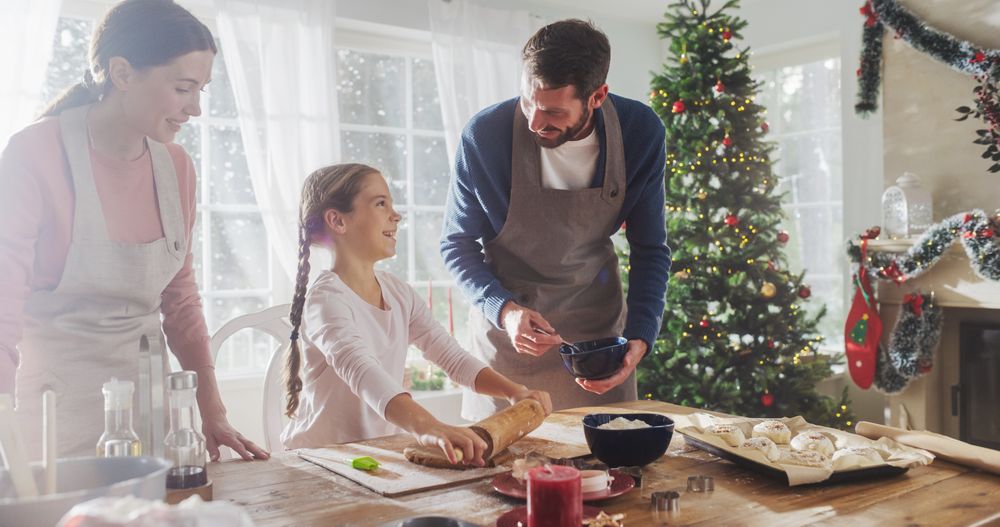 Portrait of Little Cute Girl Learning How to Make Cookies and Celebrating her Achievement with her Parents.