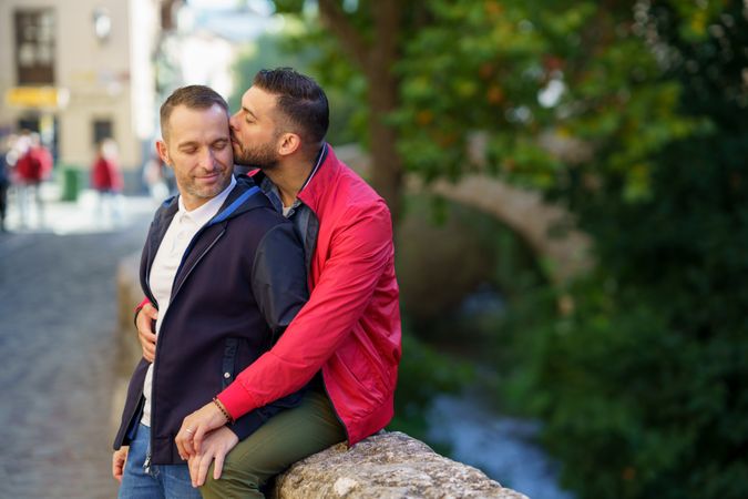 Cute male couple sitting by the river