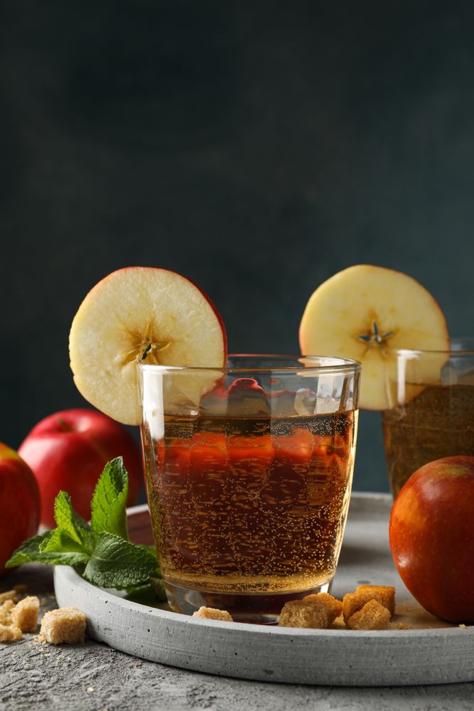 Composition with cider, sugar and apples on gray table