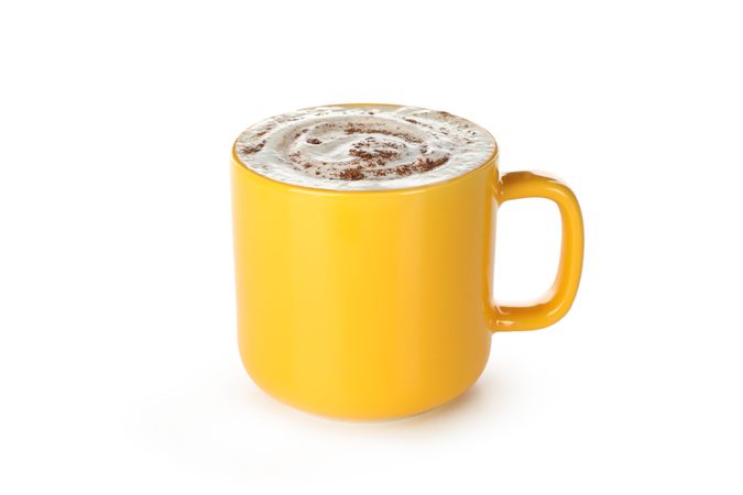 Yellow cup of latte isolated on blank background