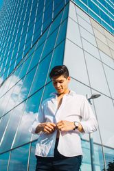 Handsome man in shirt against skyscraper