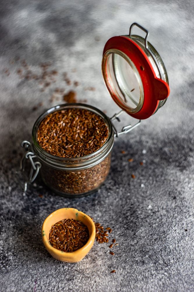 Organic food concept of pot of flax seeds