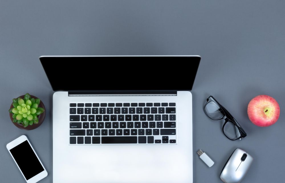 Organized gray office desk with modern computer technology