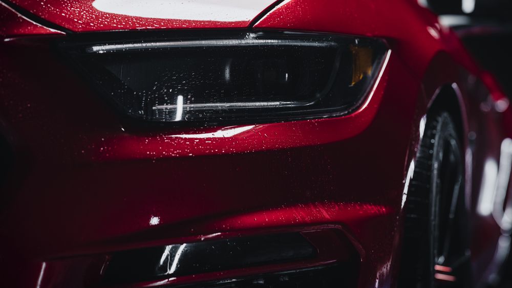 Close Up of a Modern Red Performance Car in a Dark Studio Environment.