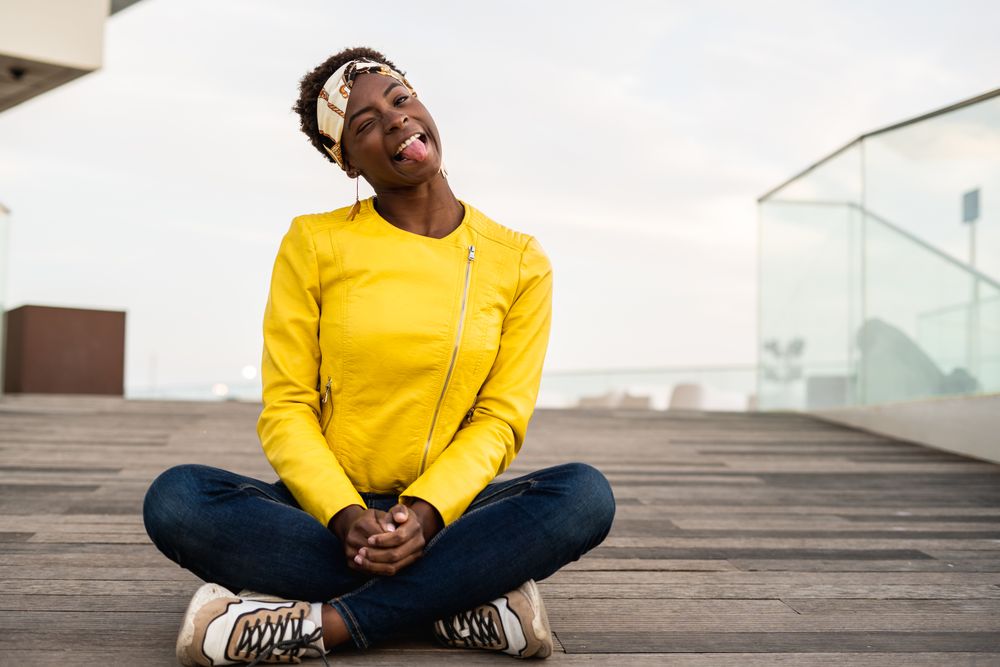 Smart woman sitting on wooden footpath