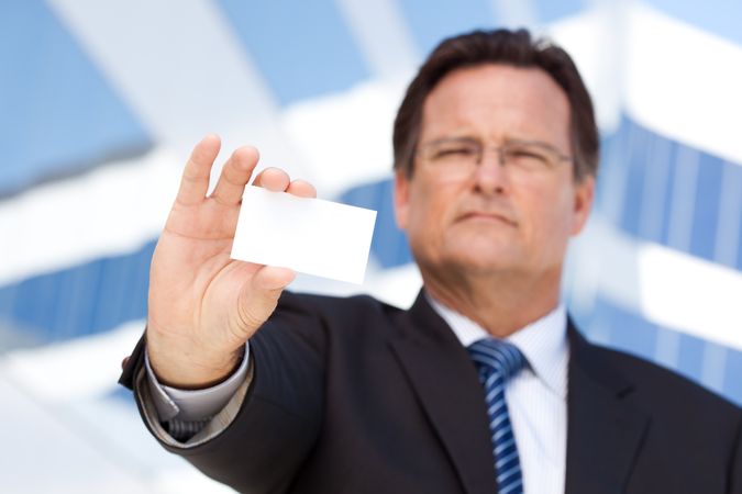 Businessman Holds Out Blank Business Card