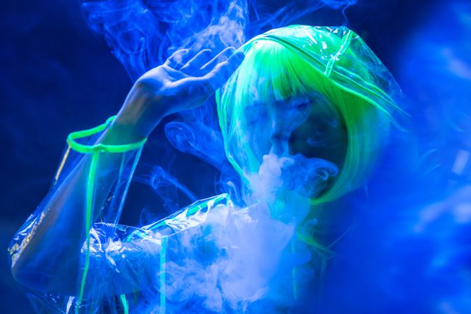 Asian woman smoking in fluorescent light