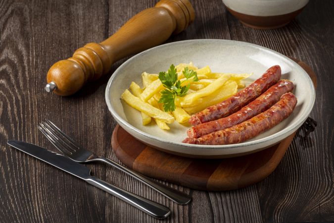 Grilled German sausage with french fries.