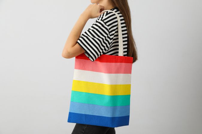 Concept of Pride parade, rainbow shopper, on color background.
