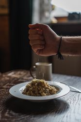 Man hand sprinkling food