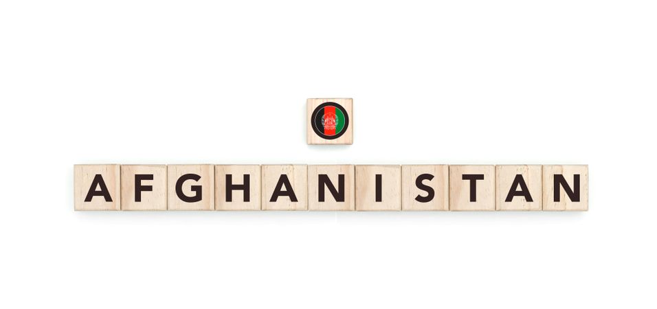 Wooden blocks bearing the name and flag of Afghanistan. Afghan, Arab and Asian Culture, national identity, travel, and geography in a copy space design.