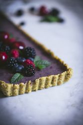 Fresh blueberry pistachio cake with whole berries on top